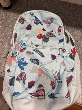 The North Face Light Blue Backpack with Multicolor Butterfly & Leaf Print